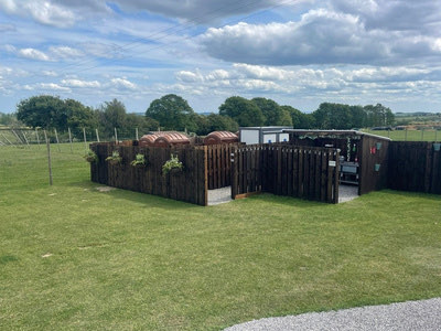 Neatly mown grass pitches bordered by hedging