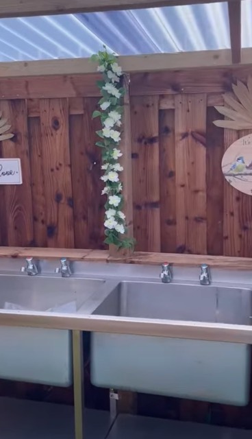 Clean outdoor wash-up sinks in the facilities block at Stag Park Caravan Site